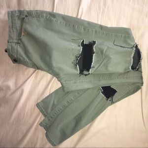 Skinny fitted distressed dark green pants.